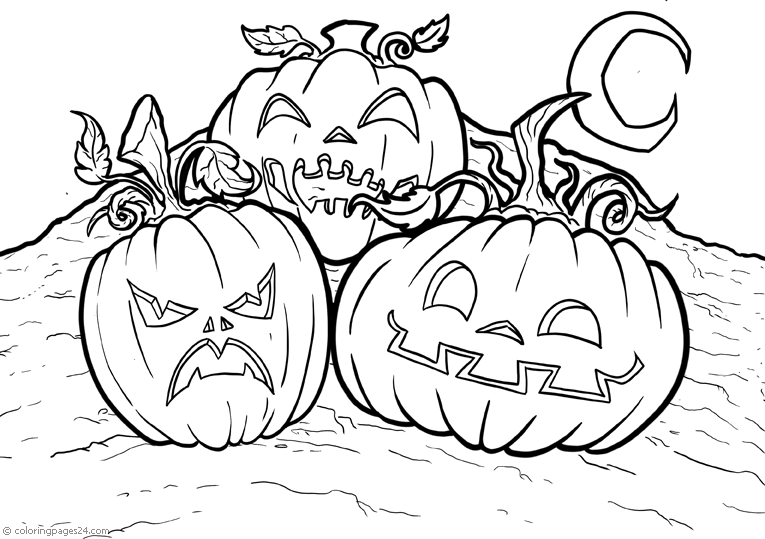 Tre stora halloweenpumpor som ligger på marken